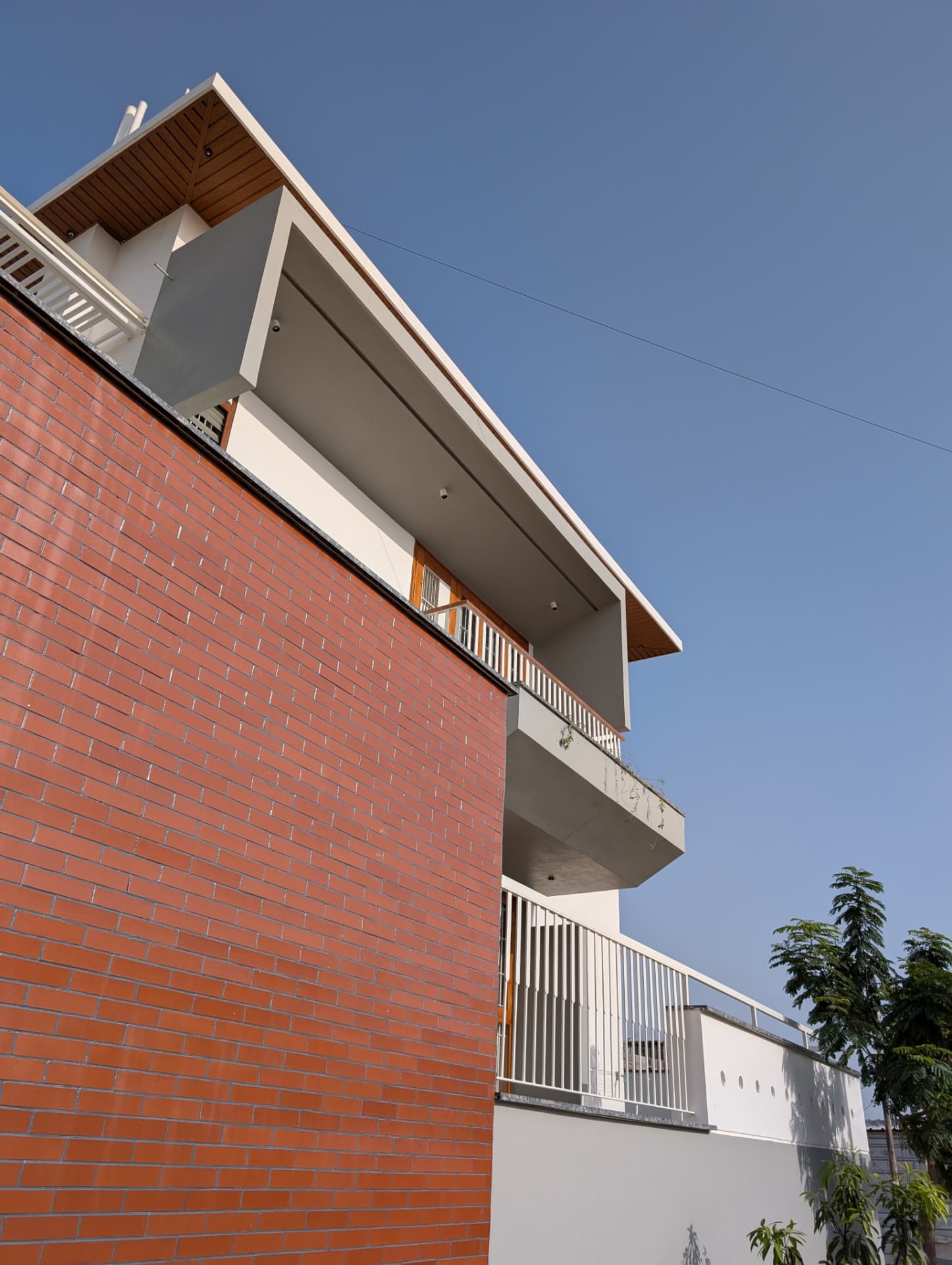 Mr. Naresh's Residence — Brick façade & cantilevered balconies